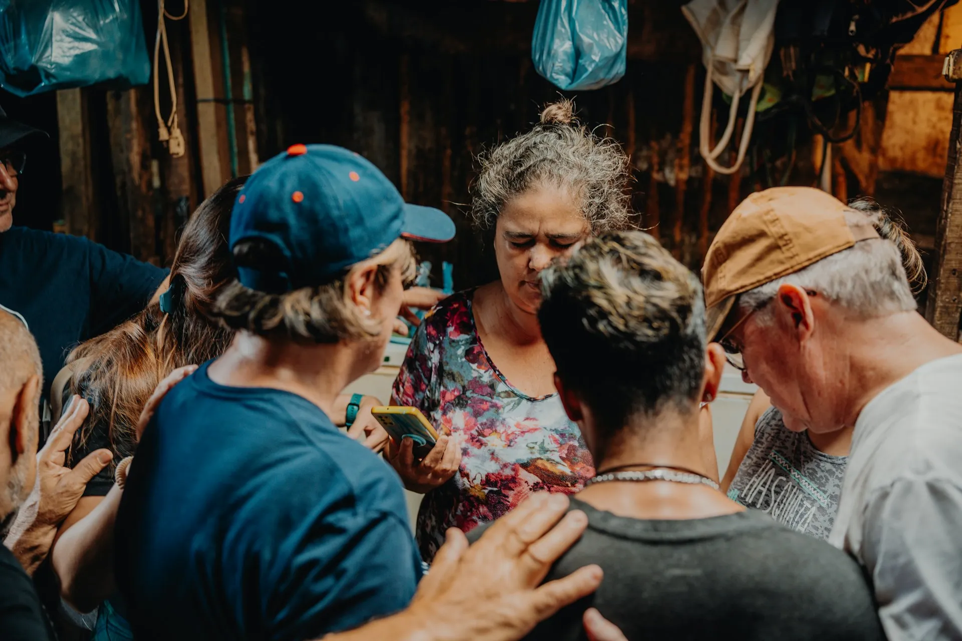 a group of people standing around each other, Praying for those in need in Costa Rica